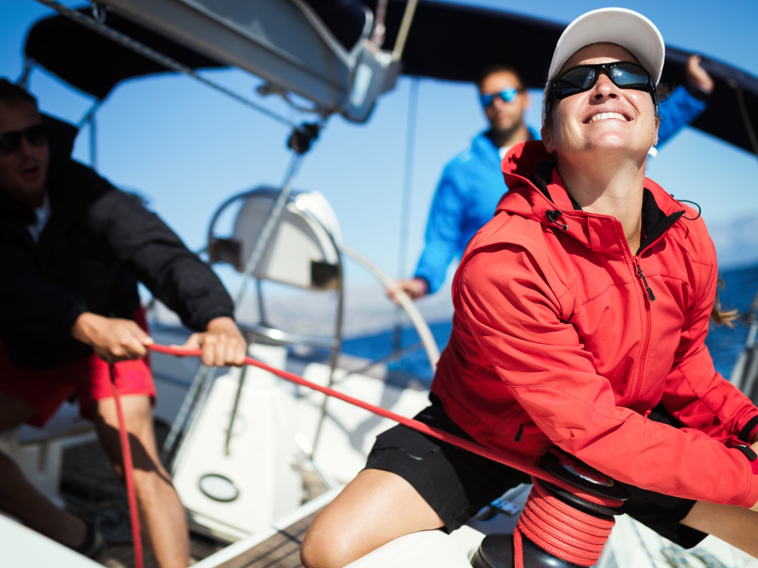 a girl with red jacket enjoying her experience on Beginning Sailing (ASA 101)